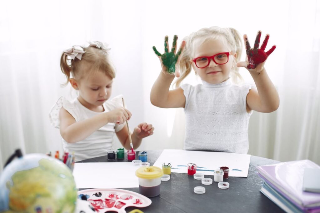 Children exploring colourful paints